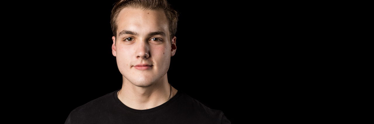 What to Know If Your Son or Daughter Says They Are Depressed photo of contributor's son holding arm out with words "I can see the daylight again" written on skin in marker pen