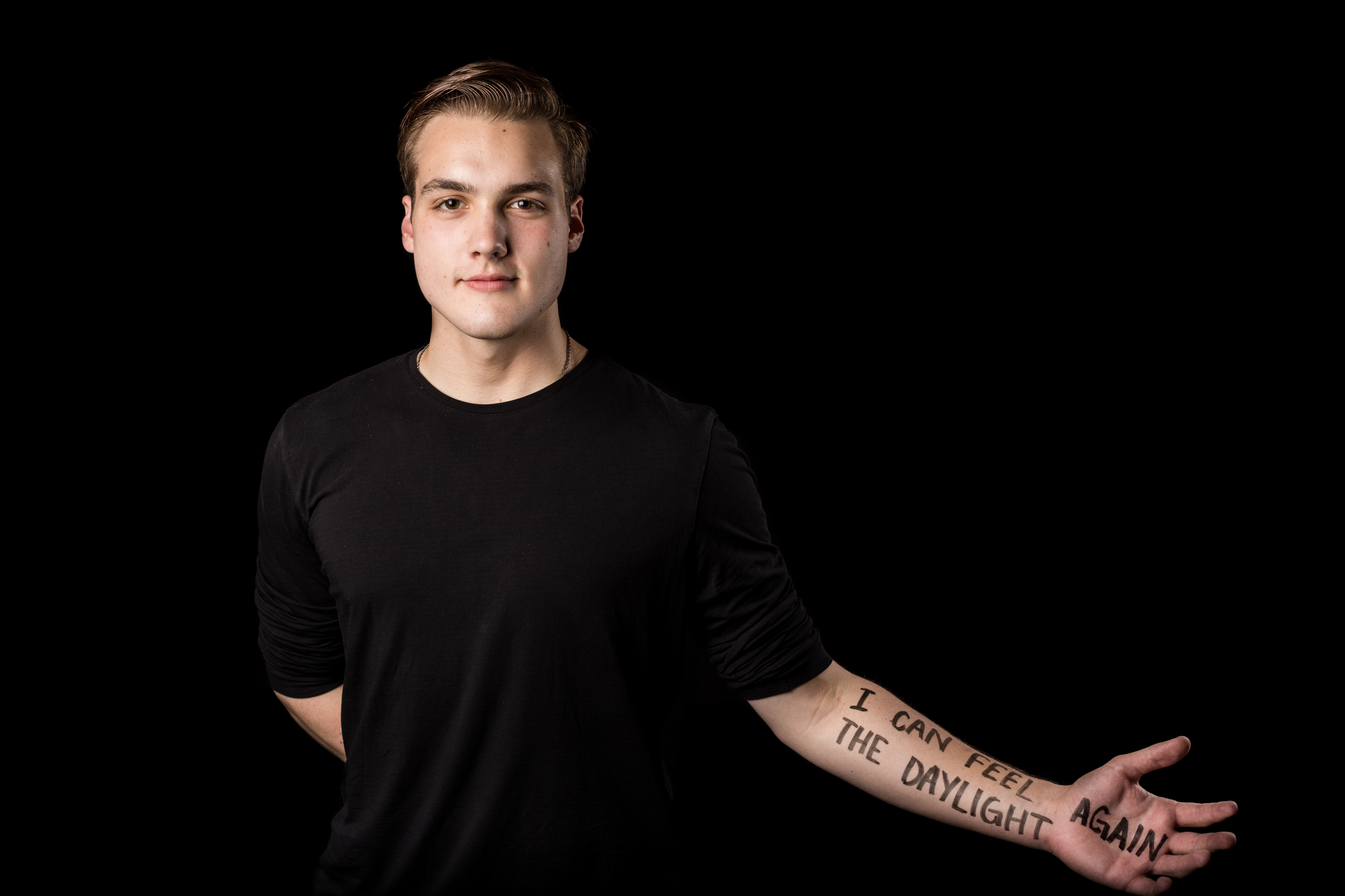 photo of contributor's son holding arm out with words "I can see the daylight again" written on skin in marker pen