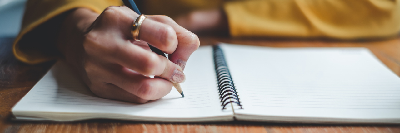 What Happened When My Friend Read My Suicide Note Close up woman hand writing on notebook