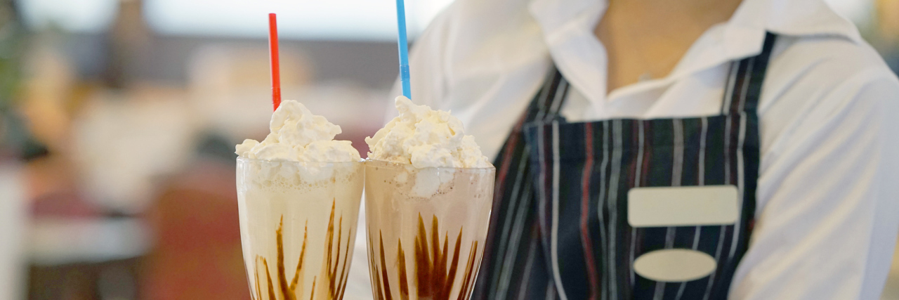 Response to the Joke, 'Diabetes on a Plate!' By Someone With Diabetes the waitress bears two vanilla milkshakes for the client of the hotel restaurant. Two chocolate dairy cocktails on a waitress tray.