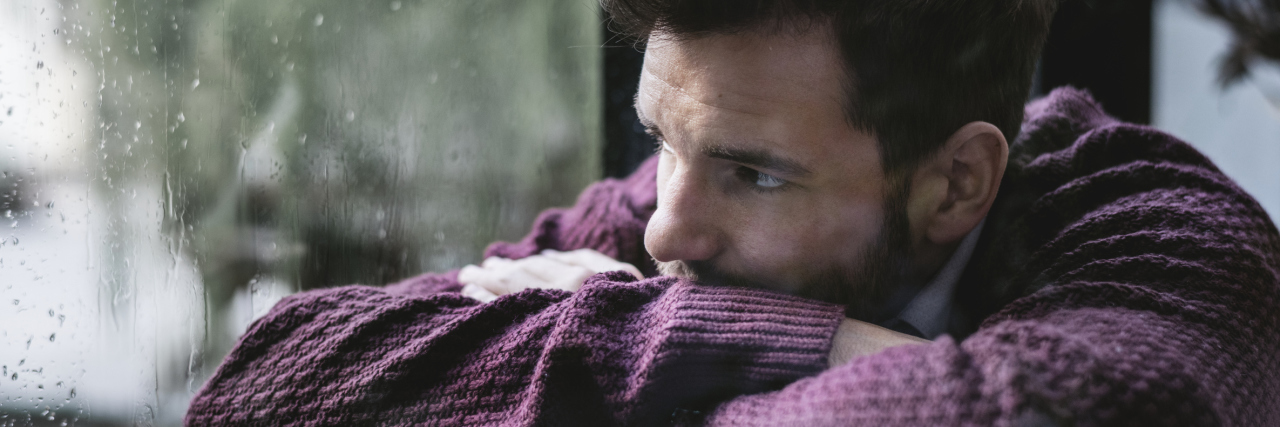 Managing the Fear and Uncertainty of Living With Chronic Illness Thoughtful man looking out the window