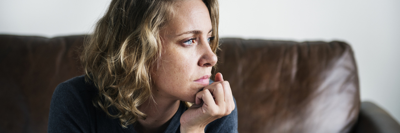 What It Would Be Like If It Didn't Have Fibromyalgia A man sitting on a couch, deep in thought