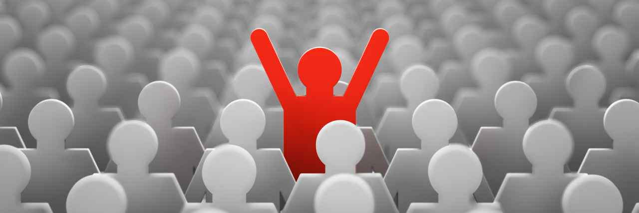 Accepting Being 'Weird' as an Autistic Person Red figure standing out in a sea of gray.