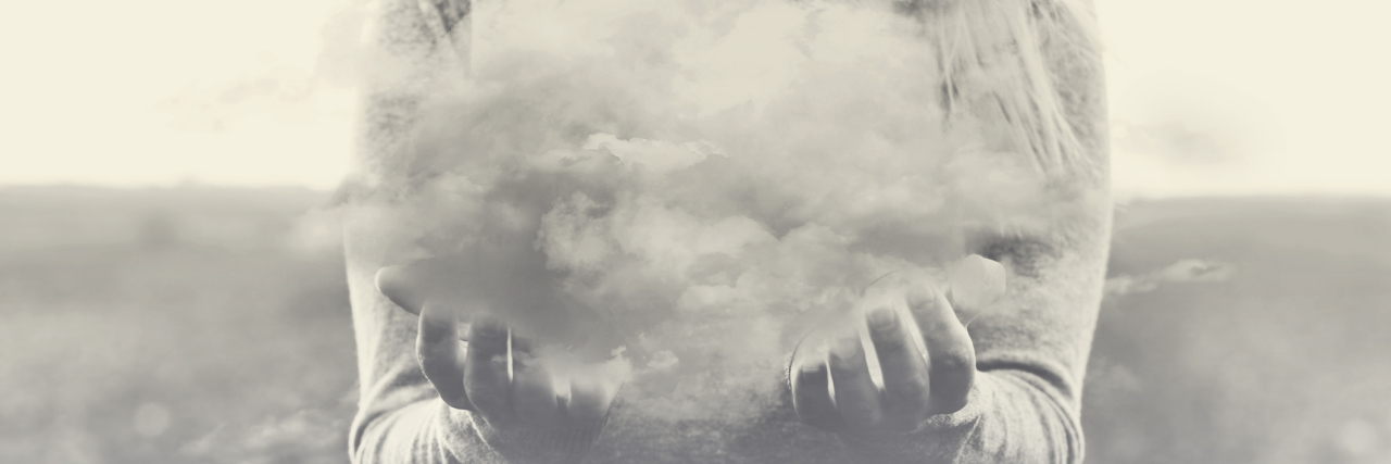 What a 'Foggy' Day With Dementia Is Like Surreal moment, solitary woman holding in her hands a gray cloud