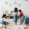 young children playing together in a playroom