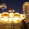 photo of a merry-go-round lit up at night, and ferris wheel