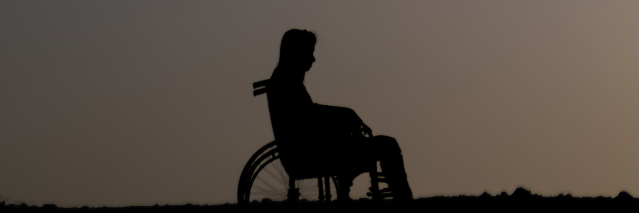 Woman in a wheelchair alone at night.
