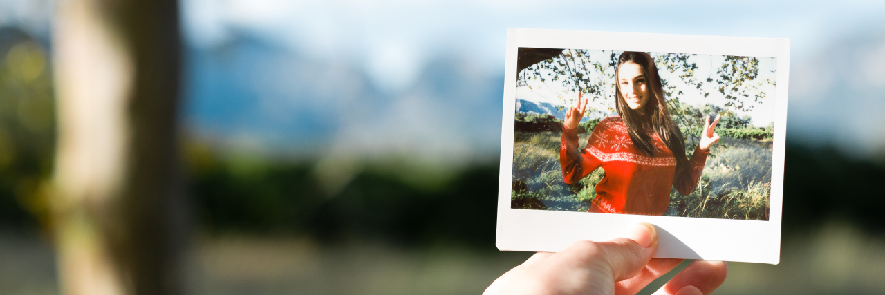 Finding Myself as a Person With a Learning Disability Hand holding a photo of a happy young woman.