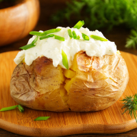 Baked potato with sour cream and chive.