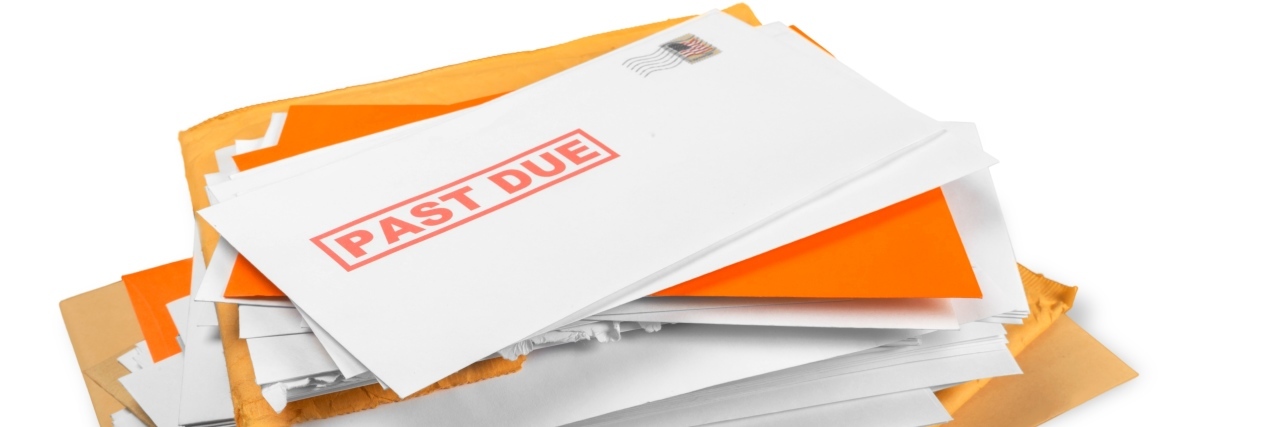 Finding Community Resources to Help With Chronic Illness Stack of past due envelopes.