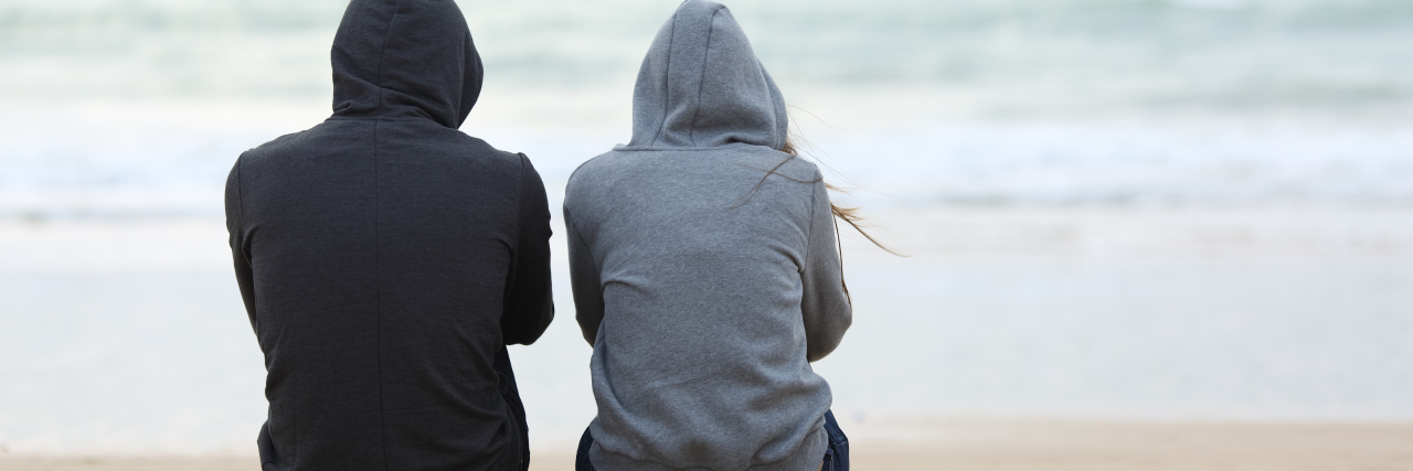 Lessons Learned After My Brother's Suicide the back view of two people sitting at the beach
