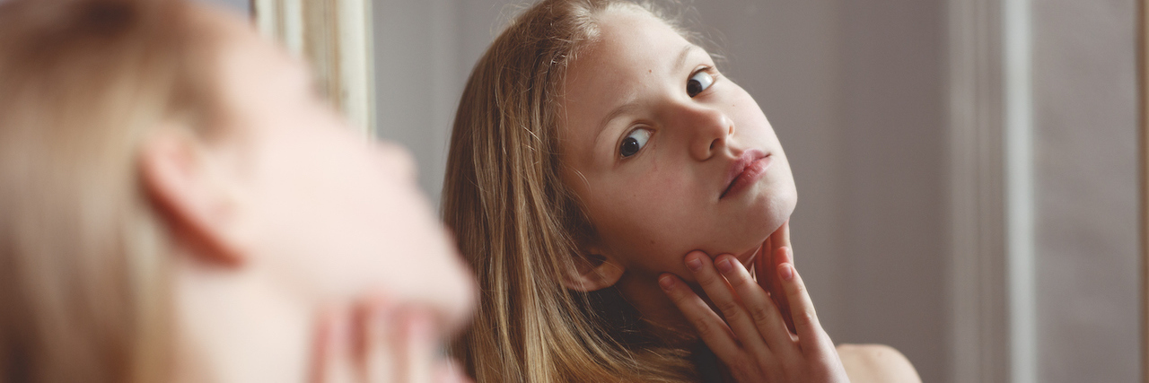 Why Sjogren's Syndrome Makes You Seem 'High-Maintenance' A woman looking at herself in the mirror