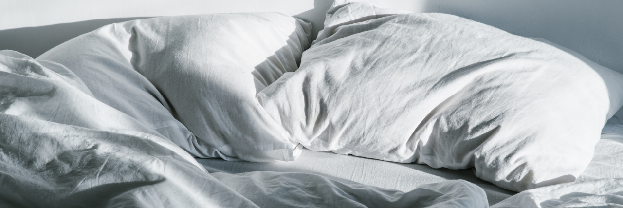 How to Be Intimate With a Partner If Penetrative Sex Is Painful crumpled bed on sunrise sun lights