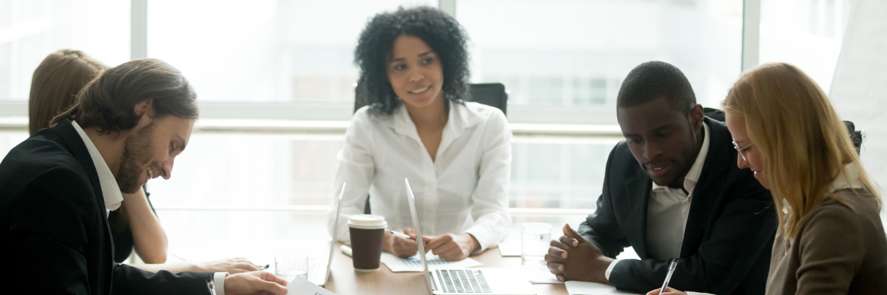 Accommodating Invisible Disabilities in the Workplace Group of people at a business meeting.
