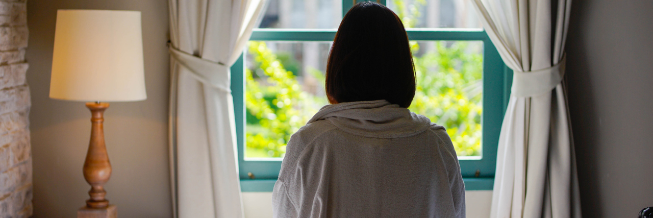 How Tyrosine Kinase Inhibitors for Cancer Take Away Sexual Desire Lone woman sitting on the bed looking out at the window in the morning