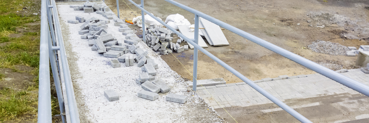 Making True Disability Accessibility a Reality Ramp with loose bricks in the middle.