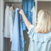 A woman reaching in her closet