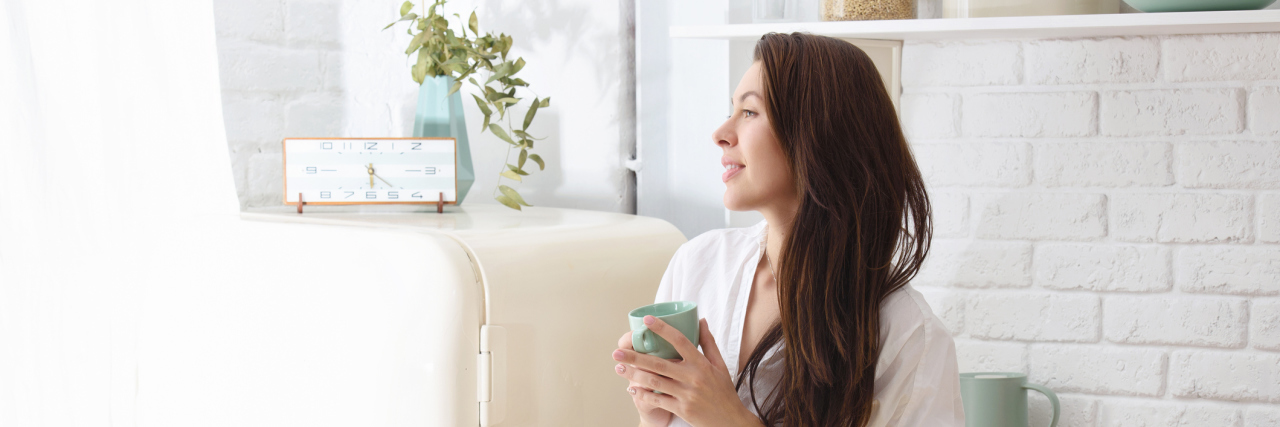Emotional Self-Care When Your Child Is Medically Complex Restful woman drinking coffee standing in her kitchen
