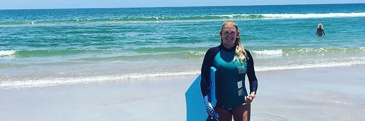 Things Not to Say to a Disabled Person in Public Kimberly standing on the beach.