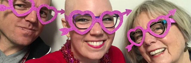 three friends wearing pink heart glasses