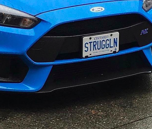 car with license plate that says; "struggln"