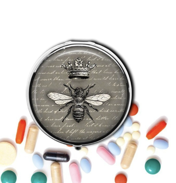 A photo of a pill box with a bee on it.