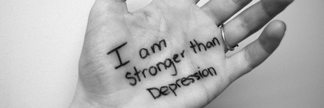 How I Wage War Against Depression palm with i am stronger than depression written on it