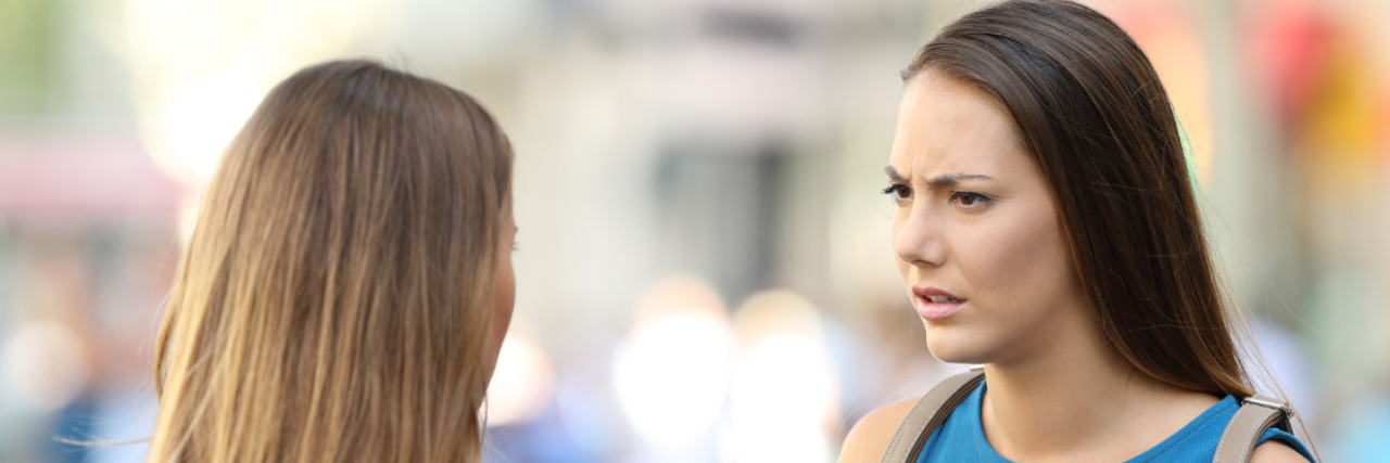 18 'Comebacks' to Use When Someone Asks Intrusive Health Questions 2 women arguing with the words 18 'Comebacks' to Use When Someone Asks Intrusive Questions About Your Health
