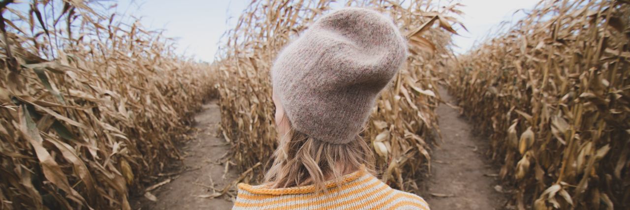 The Importance of Saying ‘I Don’t Know’ in Healthcare Woman in a cornfield looking at two diverging paths.
