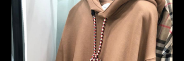 A tan hoodie with a noose tied around the neck
