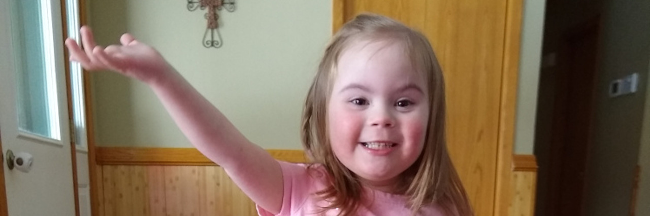 The Surprising Thing My Daughter With Down Syndrome Taught Me Little girl with Down syndrome wearing a pink tutu and dancing