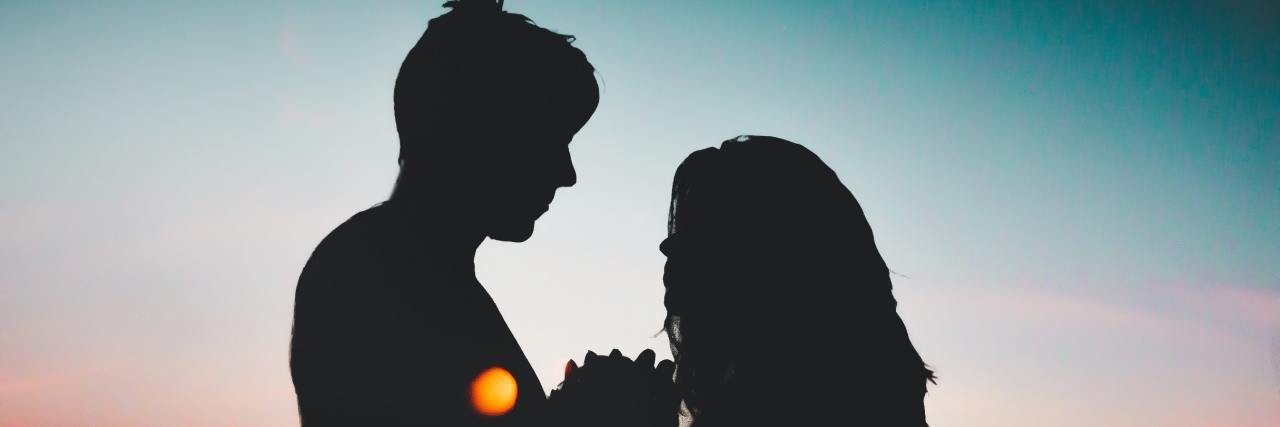 Navigating Romantic Relationships as an Autistic Adult Silhouette of man and woman couple in the moonlight.