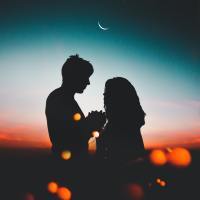 Silhouette of man and woman couple in the moonlight.
