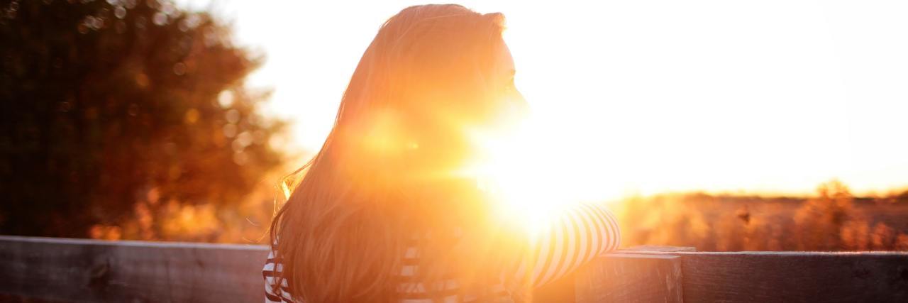 Why I Remind Myself to Be Content With My Diabetes Technology woman looking at sunrise