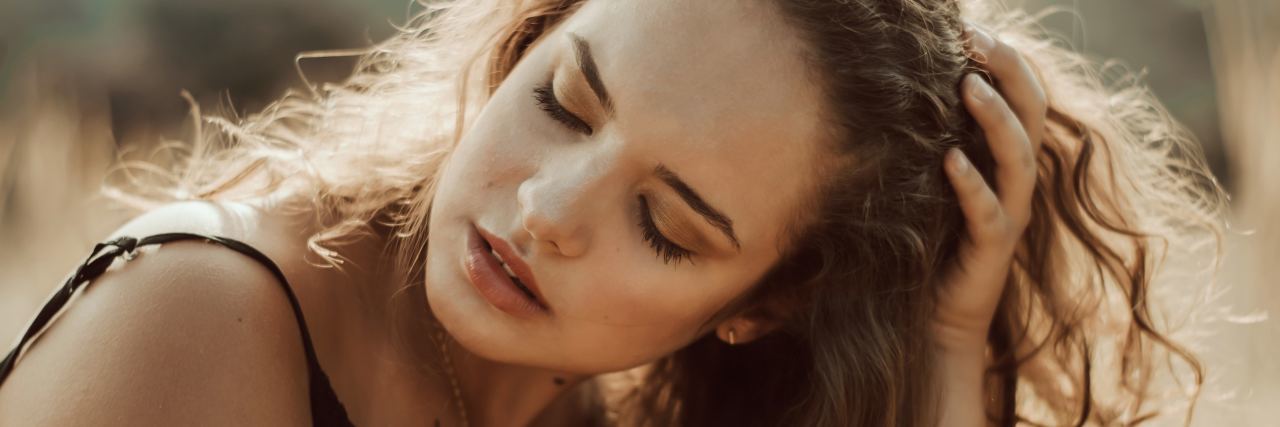 Why My Eating Disorder Is About Safety, Not Control photo of woman in desert area with hand in hair