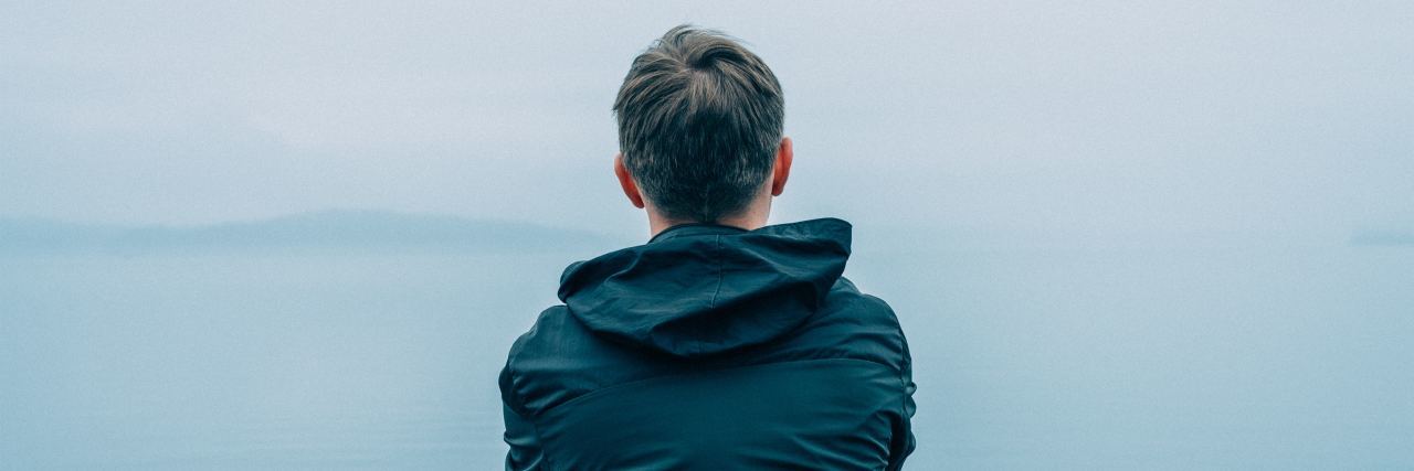 Tips to Tackle Borderline Personality Disorder When You’re Struggling photo of man from behind looking out at misty ocean