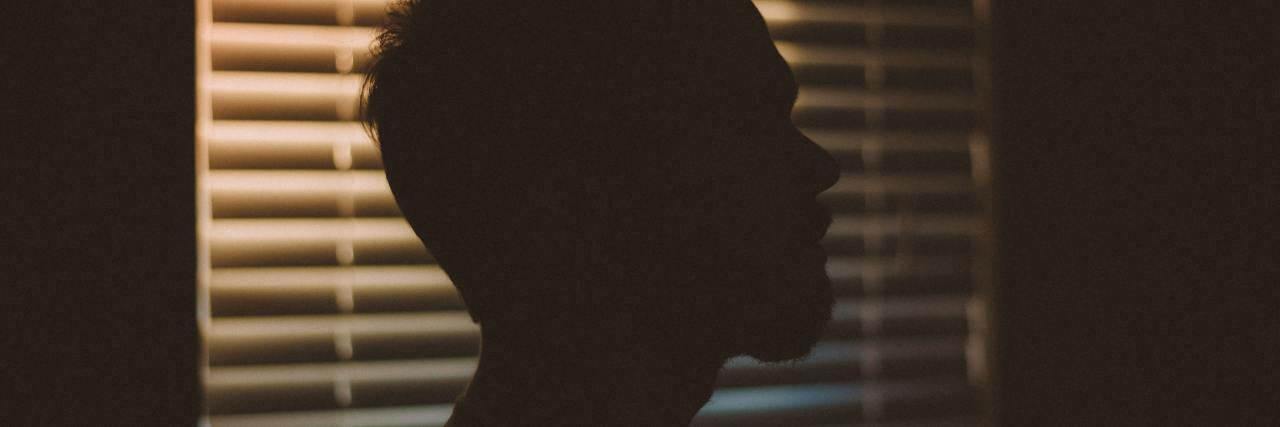 photo of man's profile silhouette against window