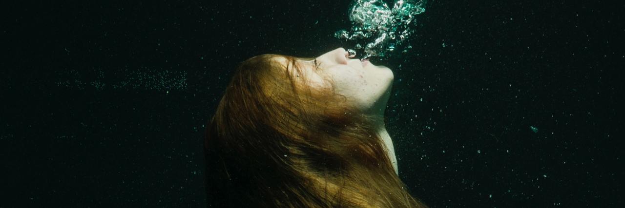 What Do You Do When You’re Struggling but Friends Need Your Help? photo of young woman in red dress underwater in darkness and hugging knees
