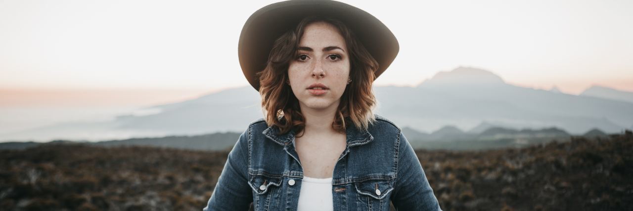 Finding Strength After Talking About Rape photo of woman wearing jacket and hat looking into camera with serious expression