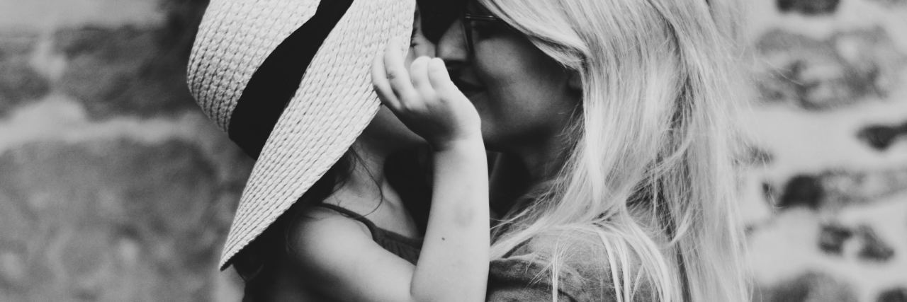 If You're a Mom Struggling With Lupus, Read This black and white photo of mother holding child close against background of stonework wall
