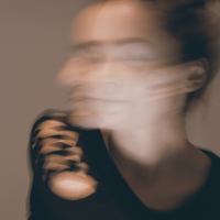 photo of woman looking away and blurred in motion