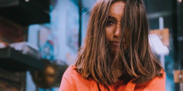 Dear Well People: Here Are 6 Things I'm Sick of Hearing A woman crossing her arms, her brown hair in her face