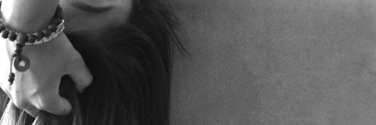Schizophrenia Makes Me Paranoid in Certain Situations black and white photo of woman's hair and part of her face looking scared