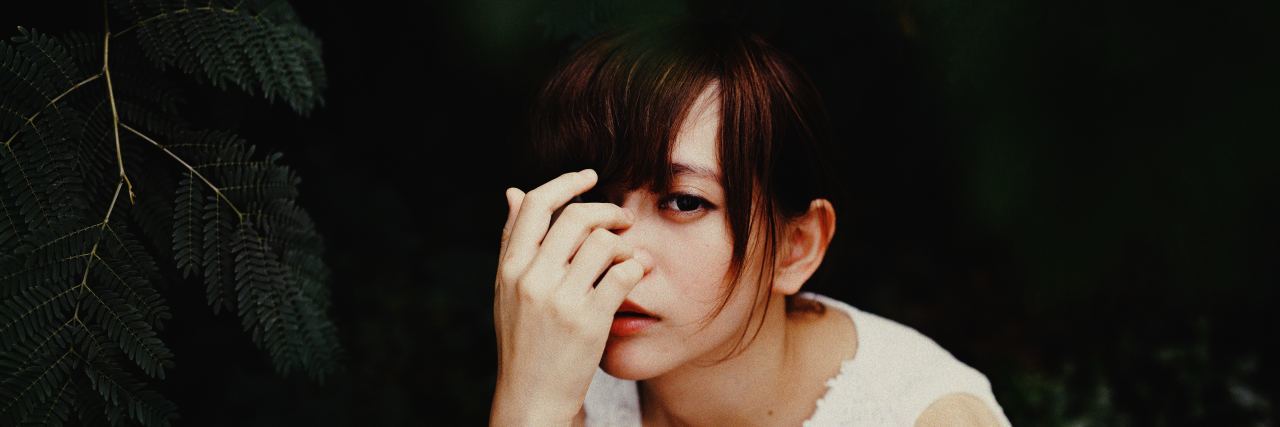 'Irrational' Things People With Anxiety Do That Others Don't 'Get' woman with head in hands