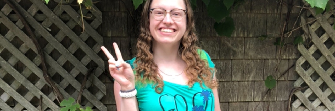 Why I Feel Like I Have to Validate My Chronic Illness two photos of woman showing peace sign with fingers. In one she is in a hospital bed, and in another she looks happy and healthy