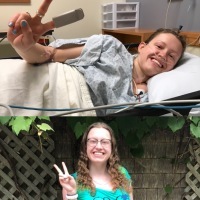 two photos of woman showing peace sign with fingers. In one she is in a hospital bed, and in another she looks happy and healthy