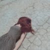 photo of redhead woman lying on cracked ground face down