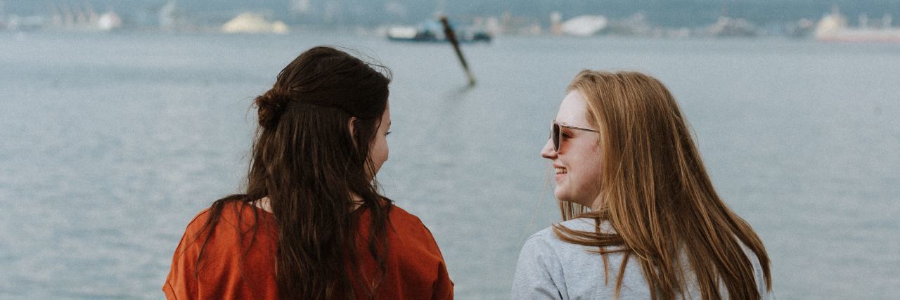 How to Avoid Hurting Someone in Eating Disorder Recovery photo of women sitting on log on beach talking