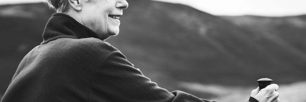 Accepting My Early Retirement Due to Chronic Illness black and white photo of older woman walking along hills