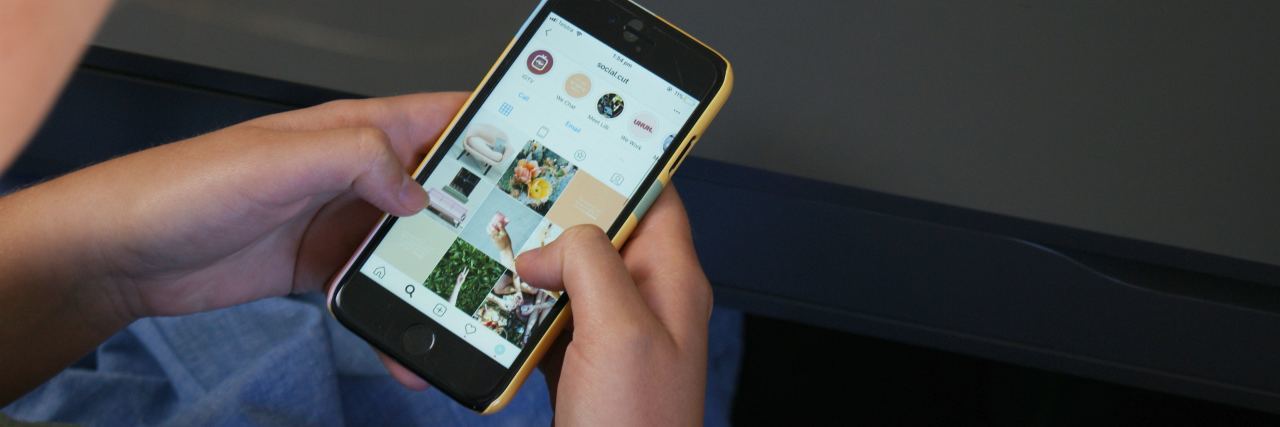 Instagram Blurring Self-Harm Images Isn't Enough close up photo of woman using smartphone to browse instagram